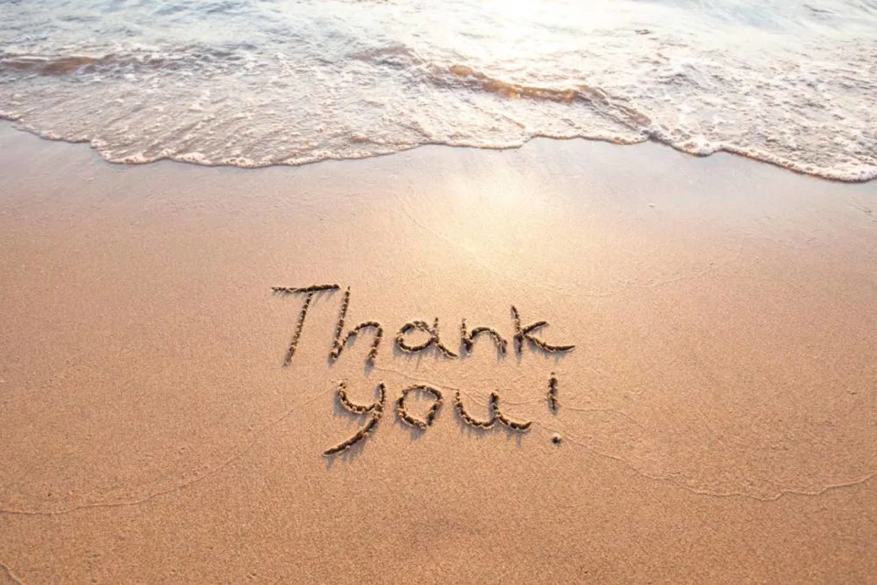 Ocean gratitude written in sand